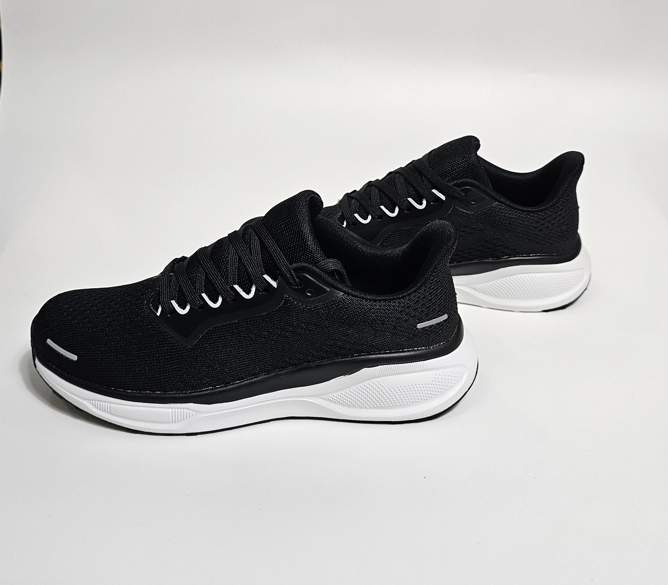حذاء رياضي أسود بتفاصيل بيضاء لمظهر عصري ومريح.